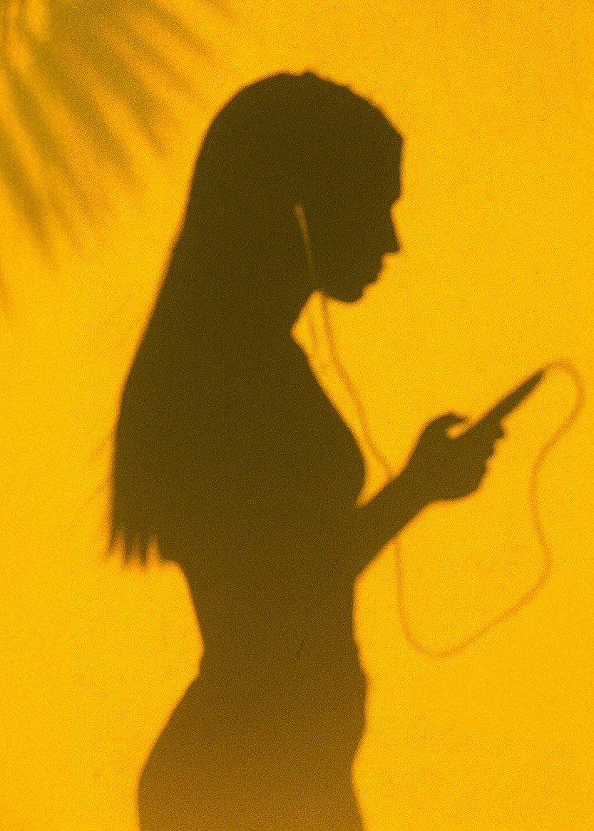 Summer Marketing Trends: shadow of woman listening to music in summer, yellow background